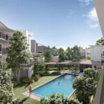 Avoca Residences pool area with a sparkling pool, sun loungers, BBQ space, and lush greenery.