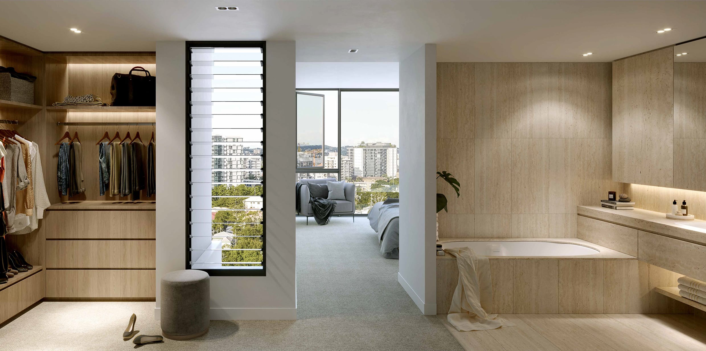 Elegant ensuite at Skye Kangaroo Point featuring Roman Travertine finishes, a built-in bath, and seamless flow to a custom walk-in robe and bedroom with city views
