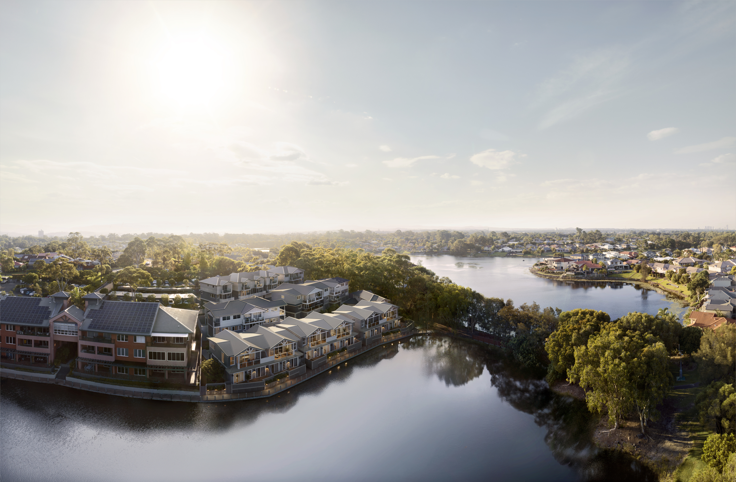 Luxury Lakeside Townhouses for Sale in Robina, Gold Coast Artist’s impression of lakeside townhouses in Robina, Gold Coast, viewed from above with waterfront balconies and surrounding greenery.